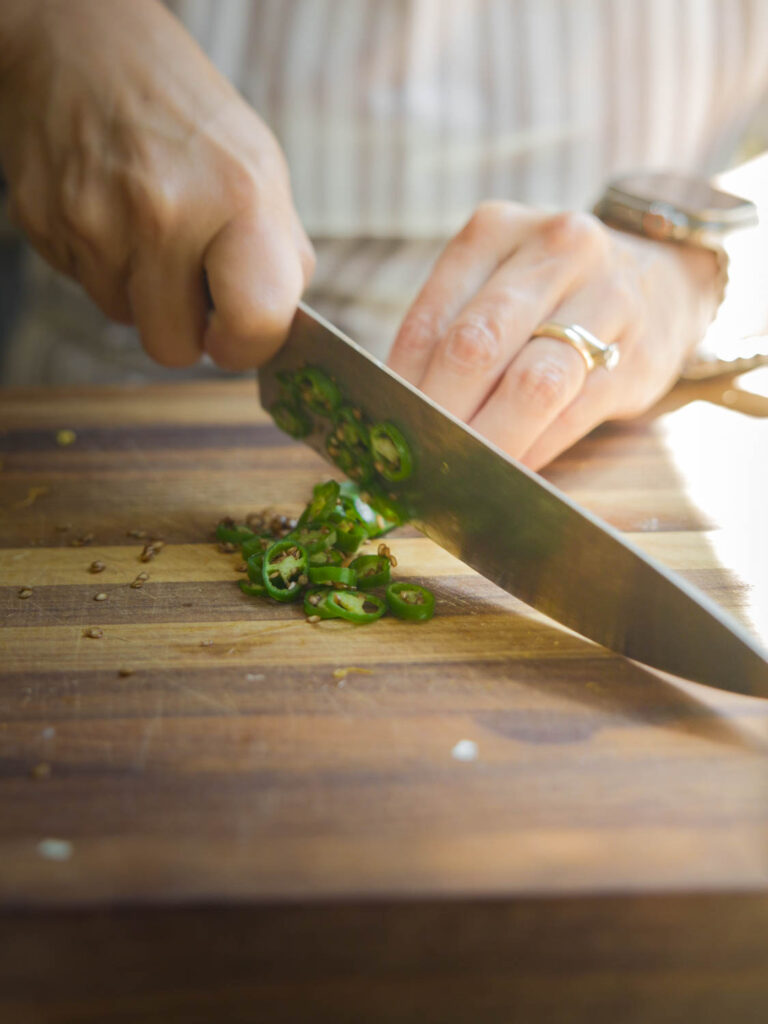 chopping up thai green chilis